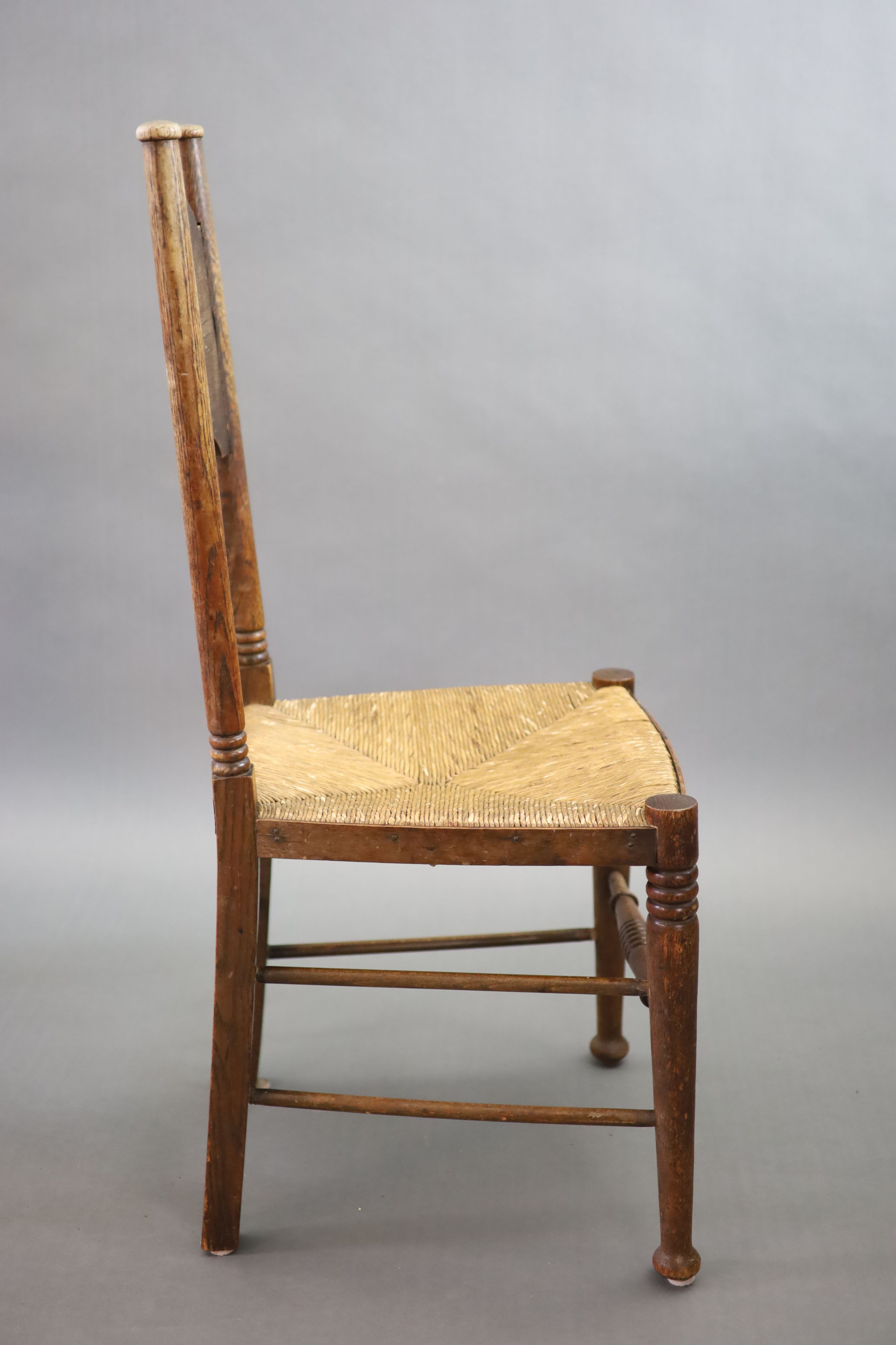 A set of six Arts & Crafts oak chairs, including a pair of carvers, in the Glasgow School manner by William Birch, High Wycombe, carvers W.58cm D.54cm H.109cm